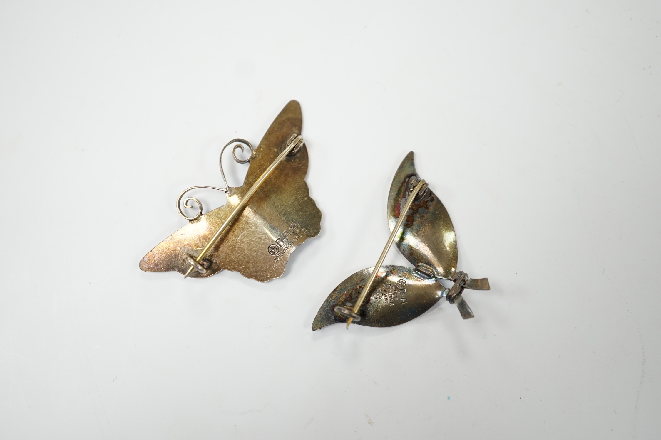 A 20th century Norwegian sterling and blue enamel set butterfly brooch by David Andersen, width 43mm and a similar double leaf brooch by David Andersen. Good condition.